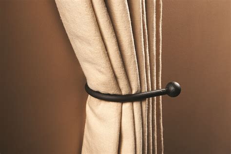 what do you call metal brackets that hold curtains back|curtain tie back anchor.